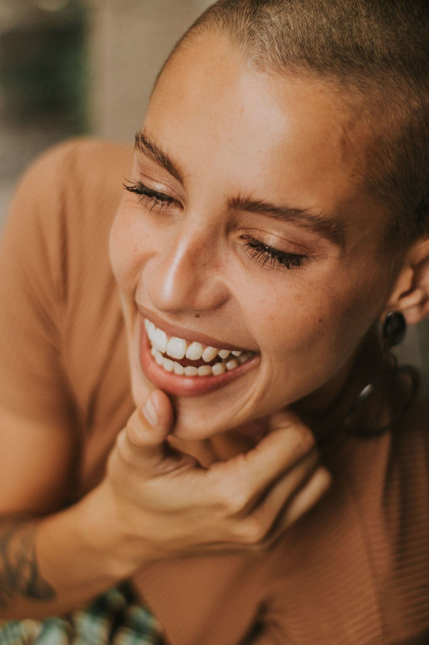 Smiling woman in tan shirt