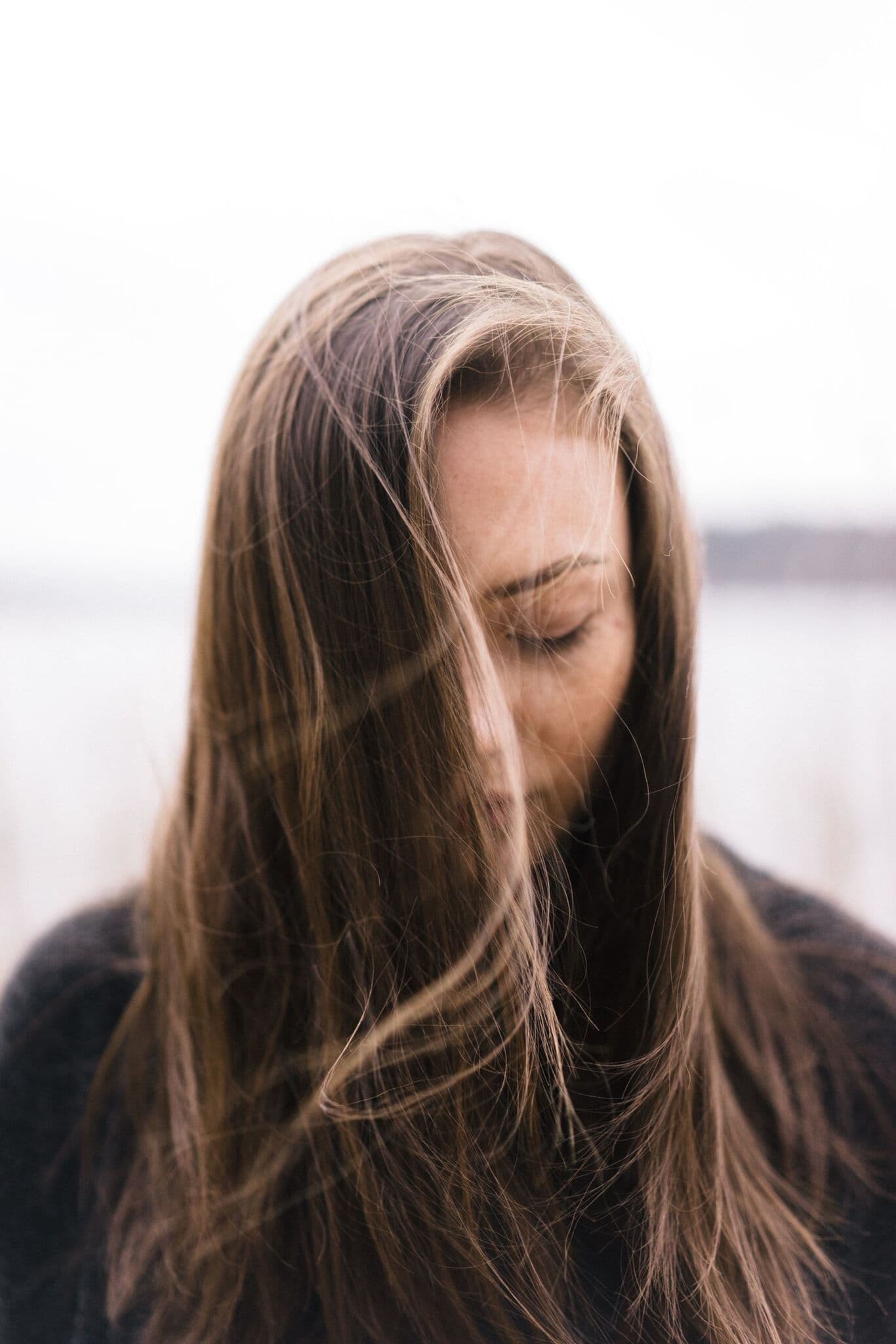 Young woman with long hair quietly meditating