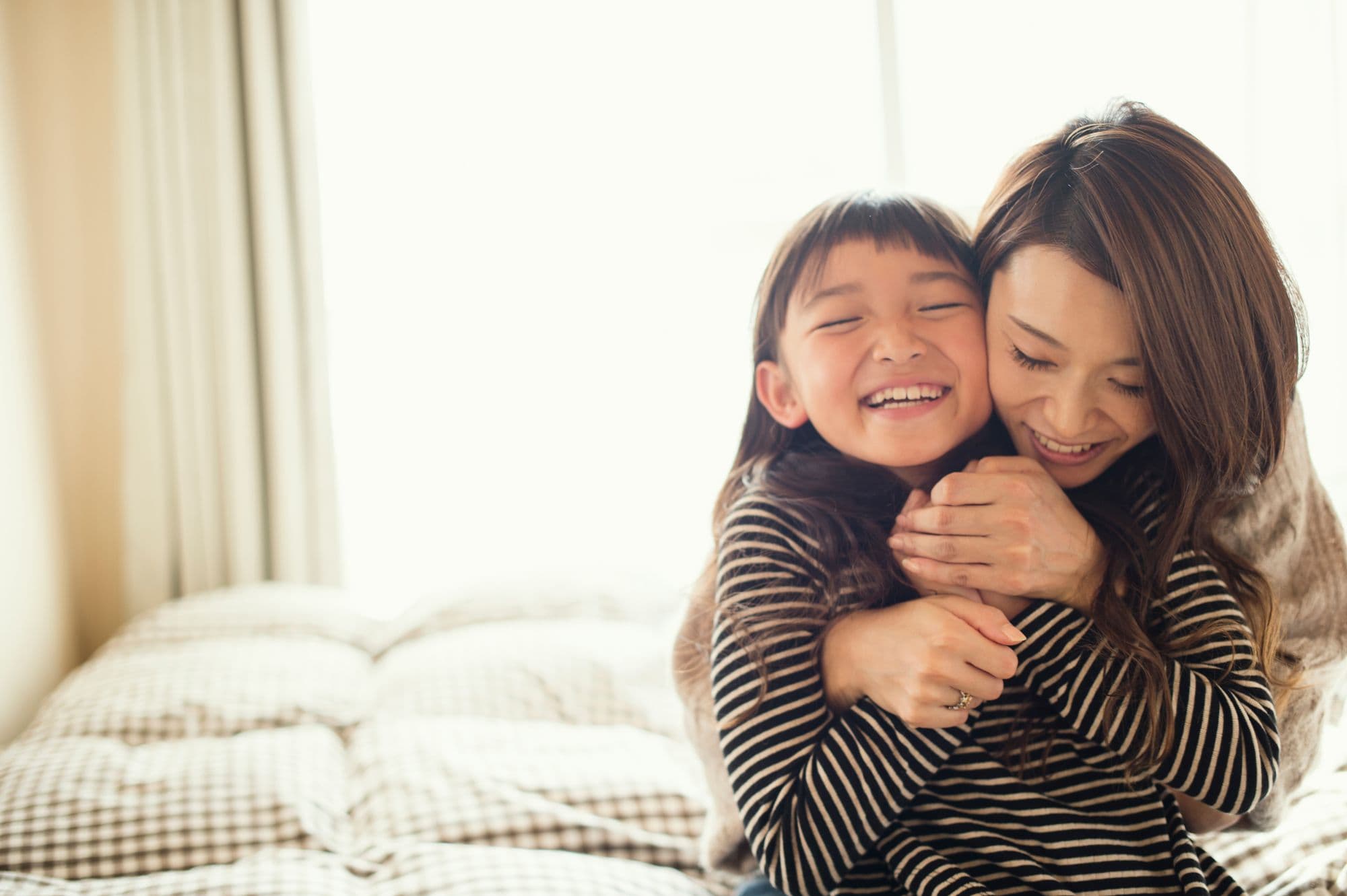 mom and daughter hugging