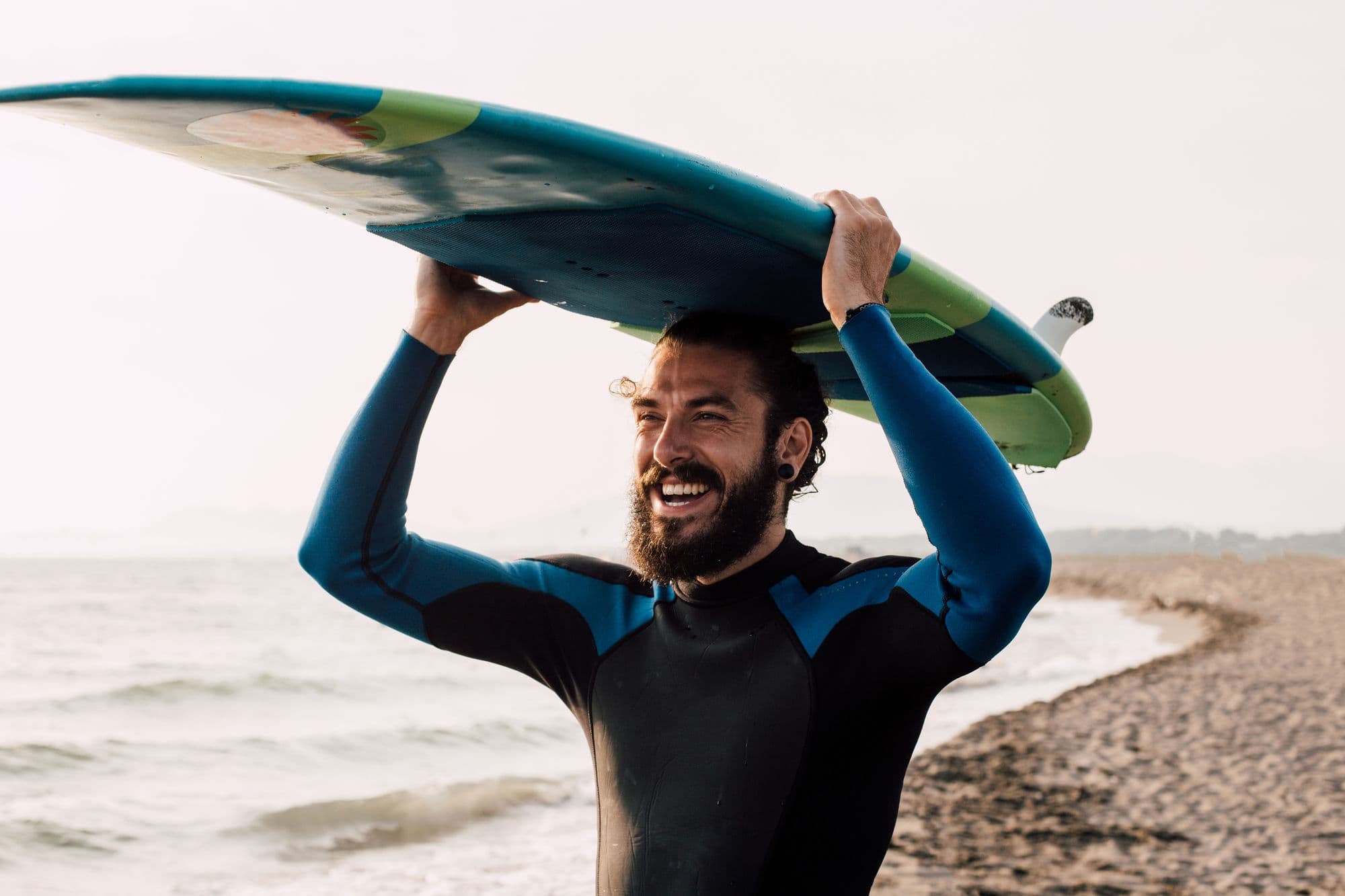 Smiling man with surfing board